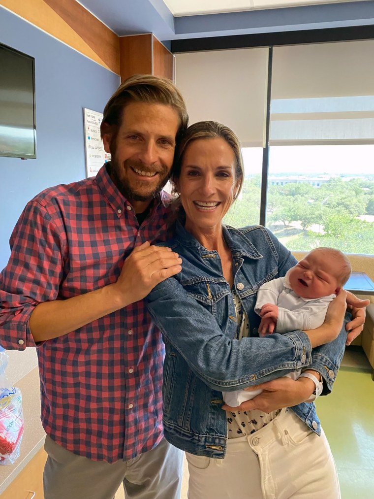 Adoptive parents hold their new baby.