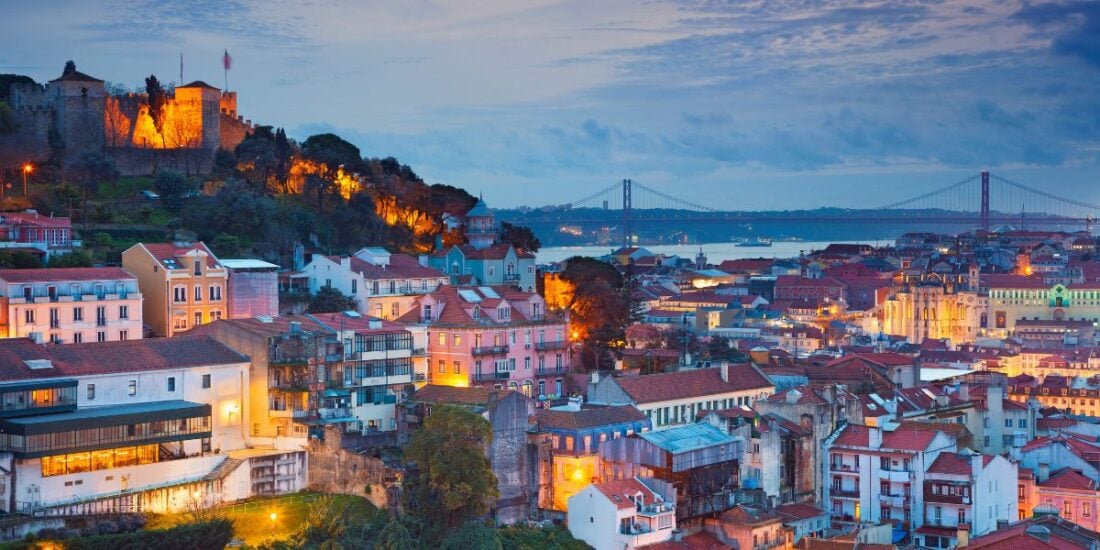lisbon city at dusk with twinkling lights