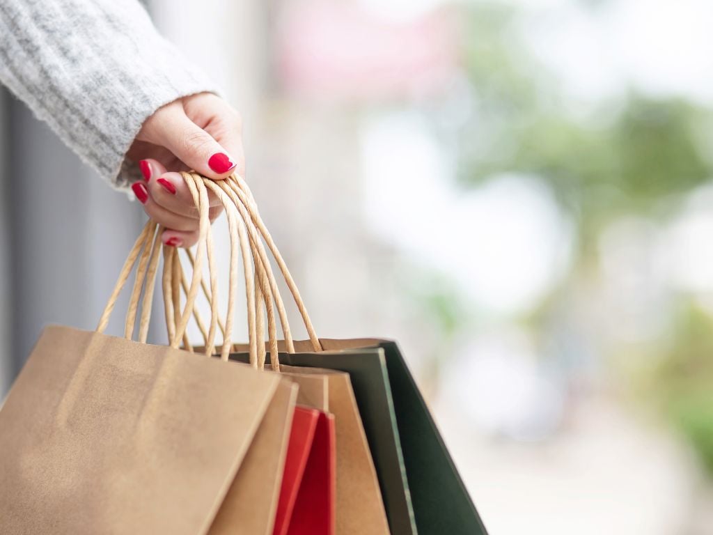 woman holding shopping bags with painted nails