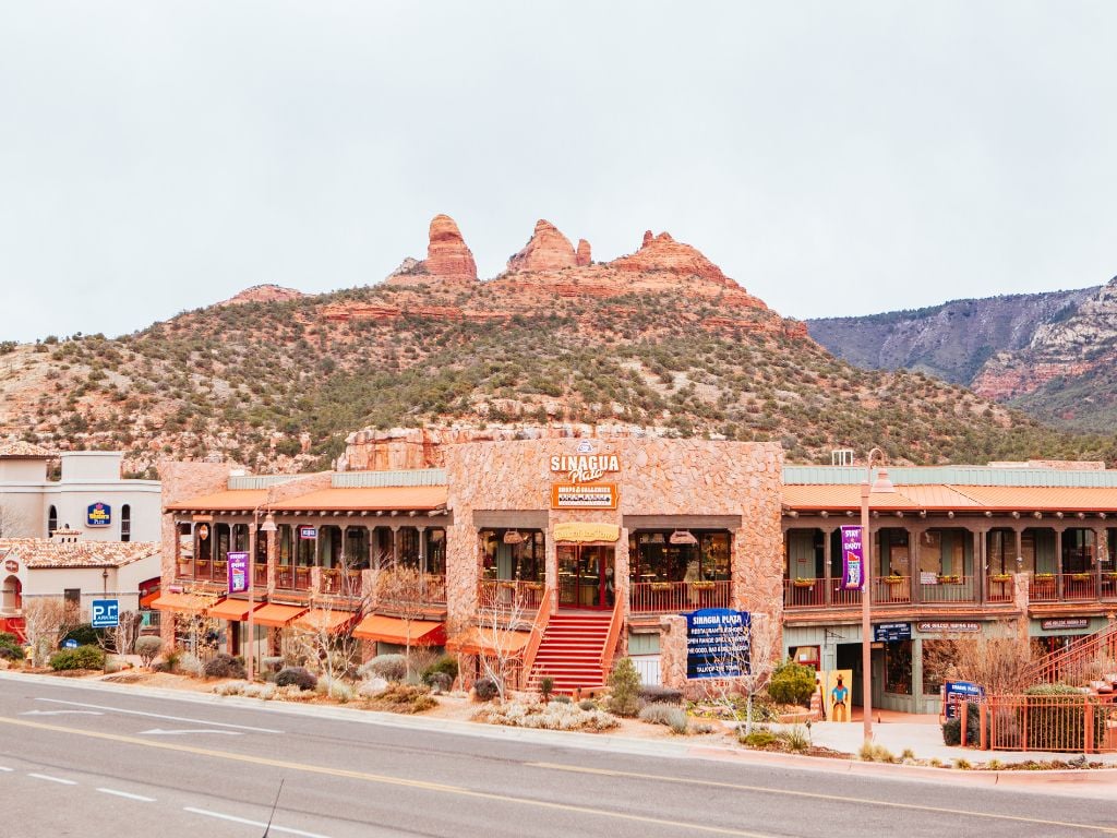 shopping strip in sedona with mountains behind it