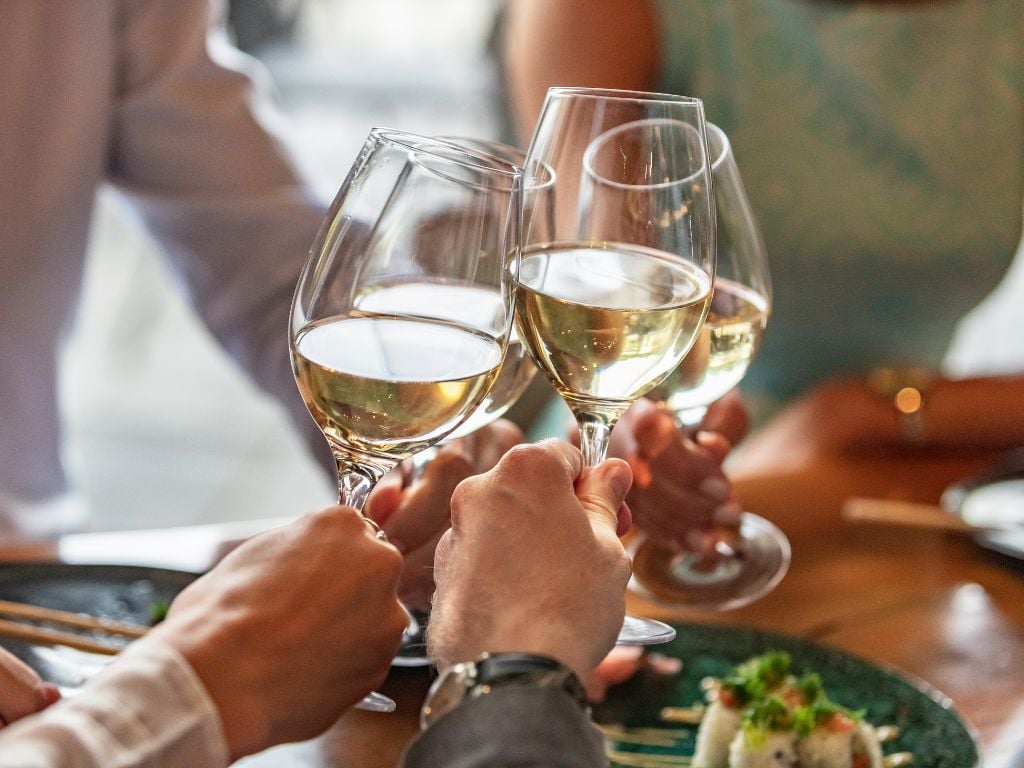 friends cheers with white wine glasses in sedona arizona
