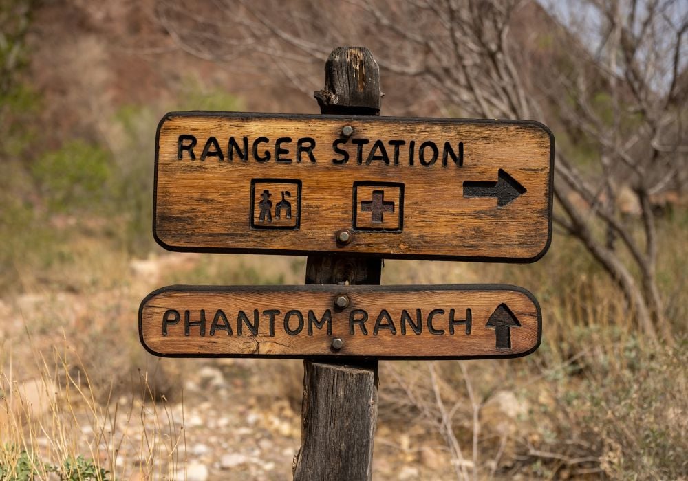 signs pointing to the ranger station and phantom ranch in arizona