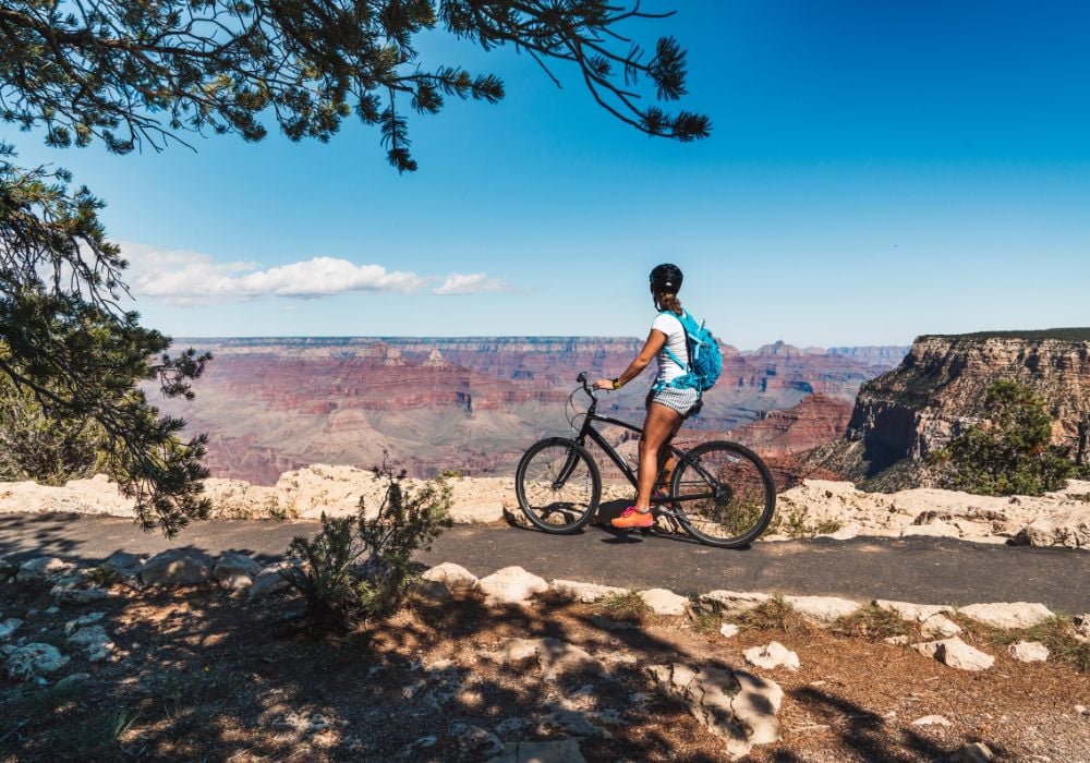 woman on a bicycle at the grand canyon