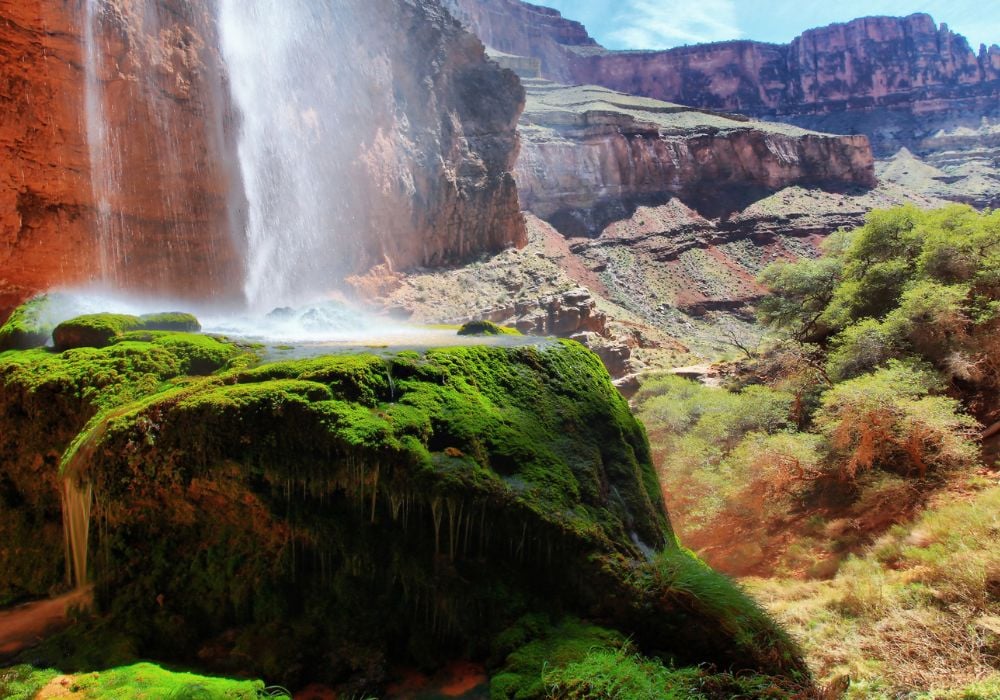 waterfall in the grand canyon with green moss covering the stone