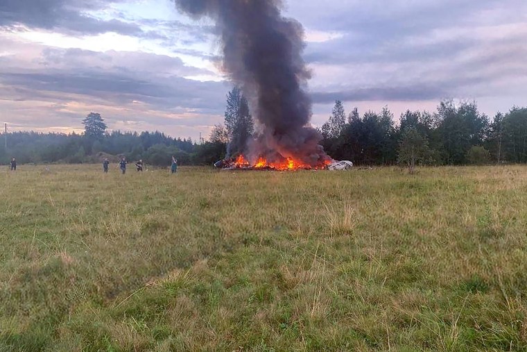 Smoke rises as a plane wreckage burns near the village of Kuzhenkino