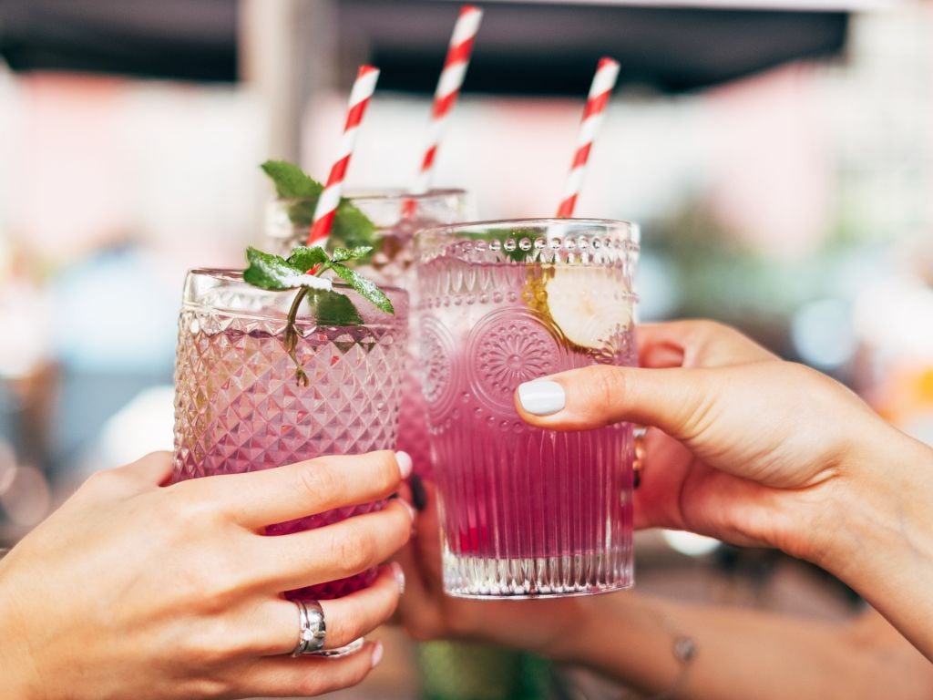 two people with cocktails cheers