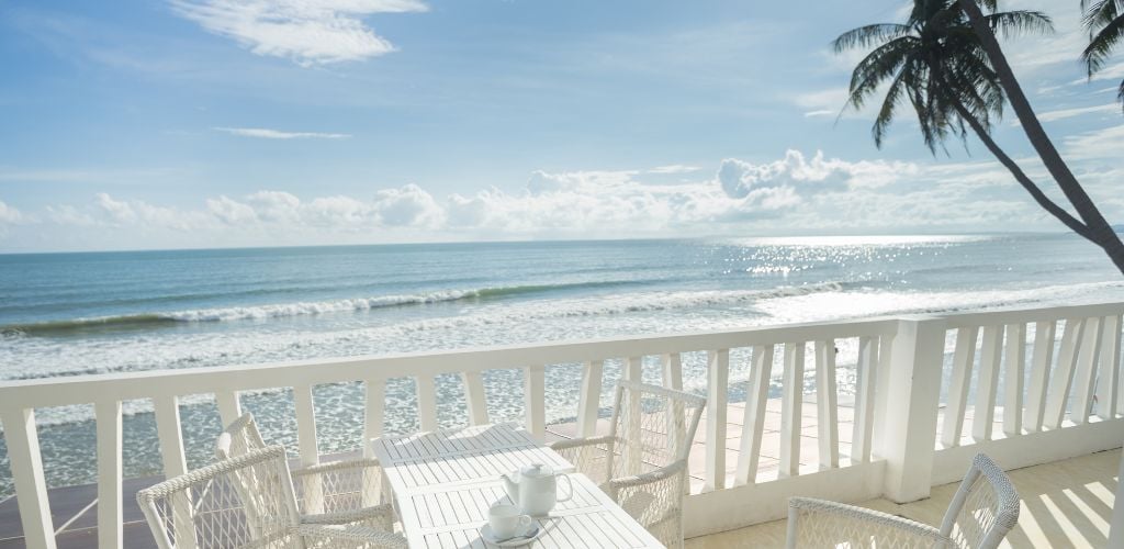 White Balcony Beach view with chairs and coconut tree