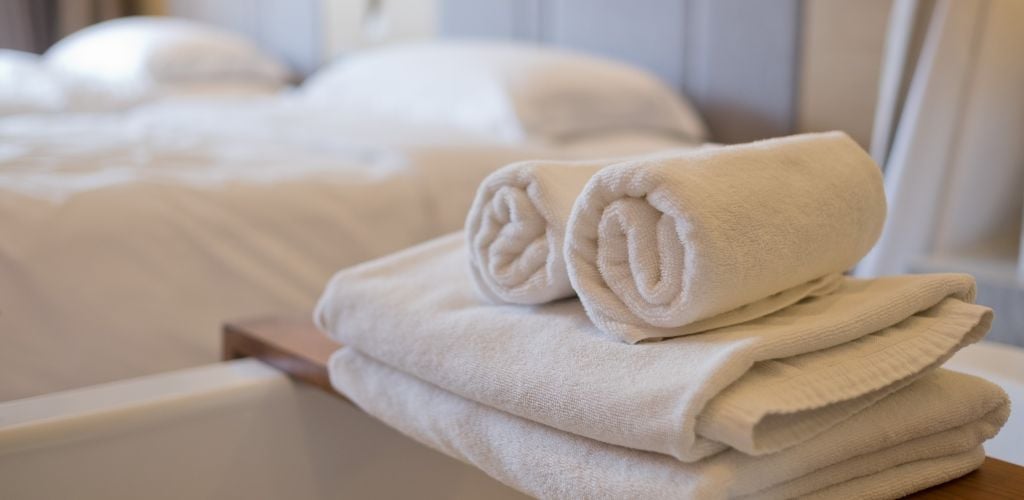 Bed for two and rolled towels