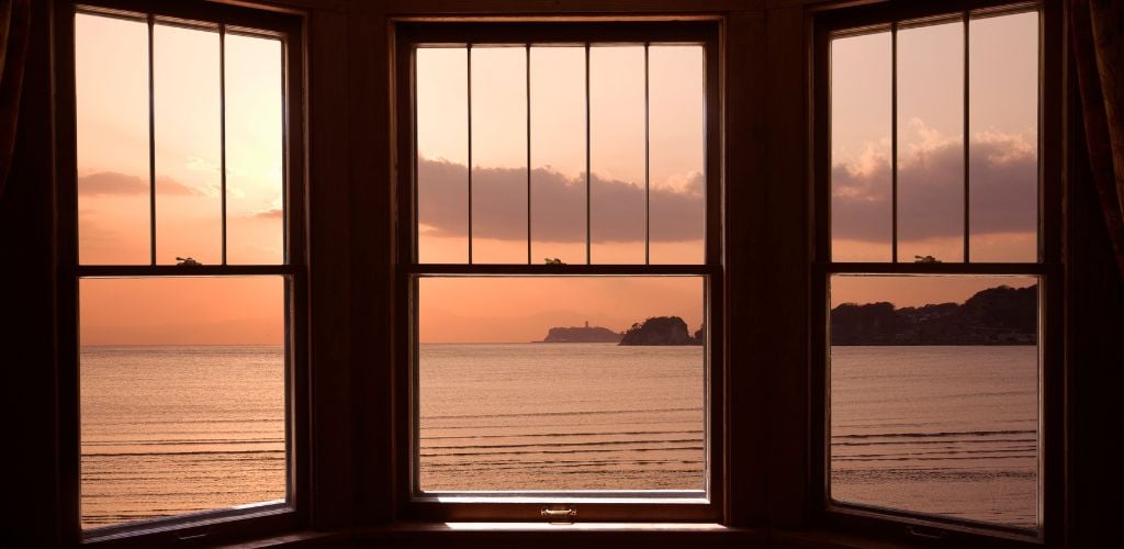 Beach front view in a window with mountain