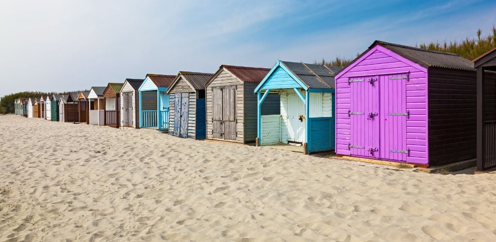 Sand with colorful bungalows in line