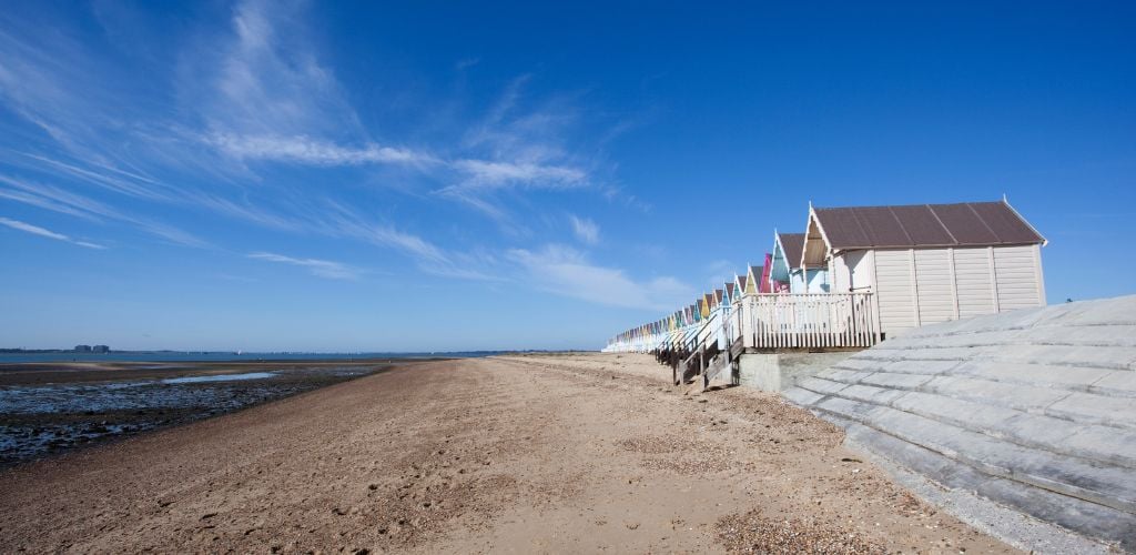 West Mersea Beach with colorful bungalows in line
