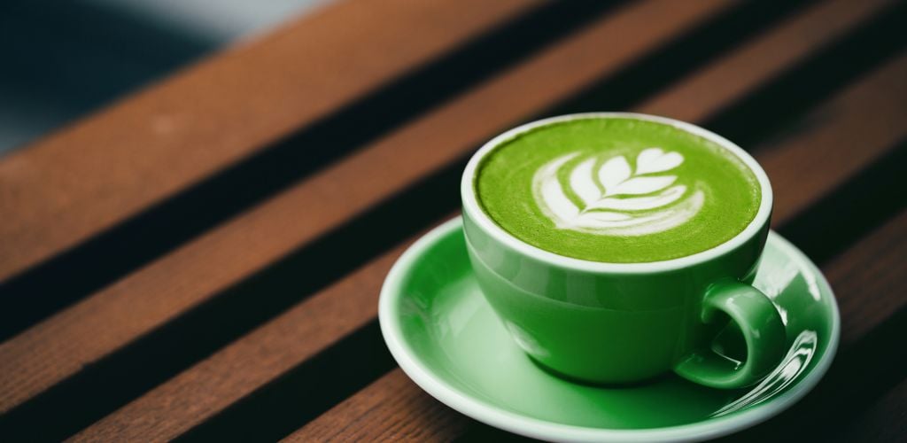 A matcha coffee on a wooden platform