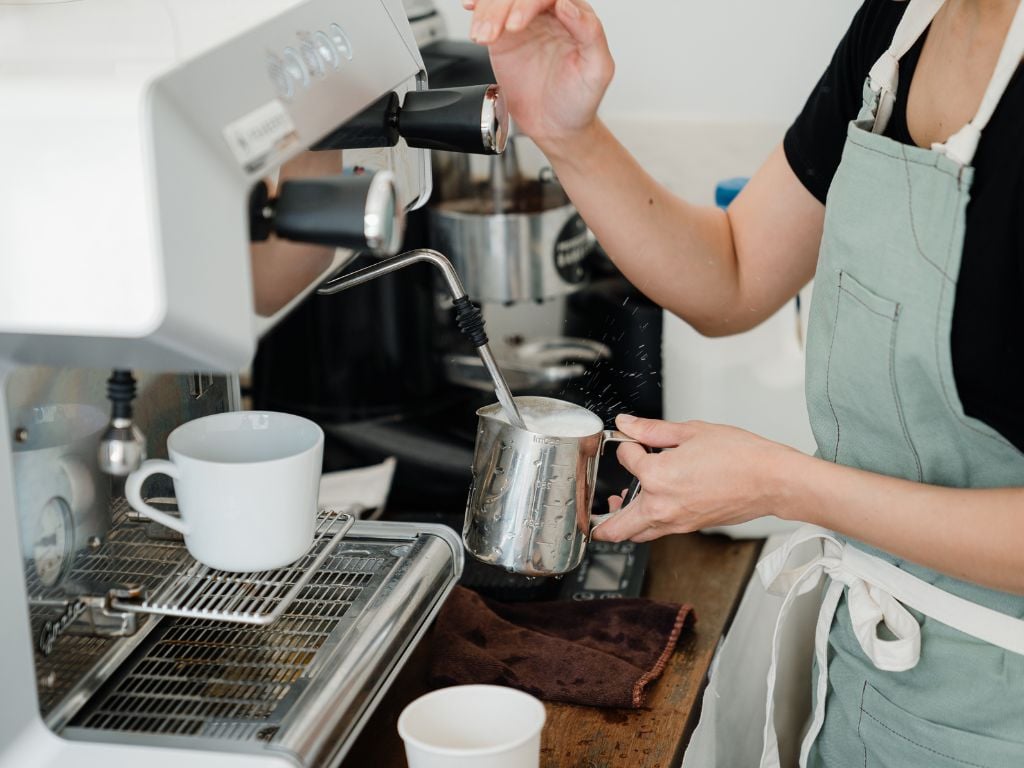 barista steaming some milk