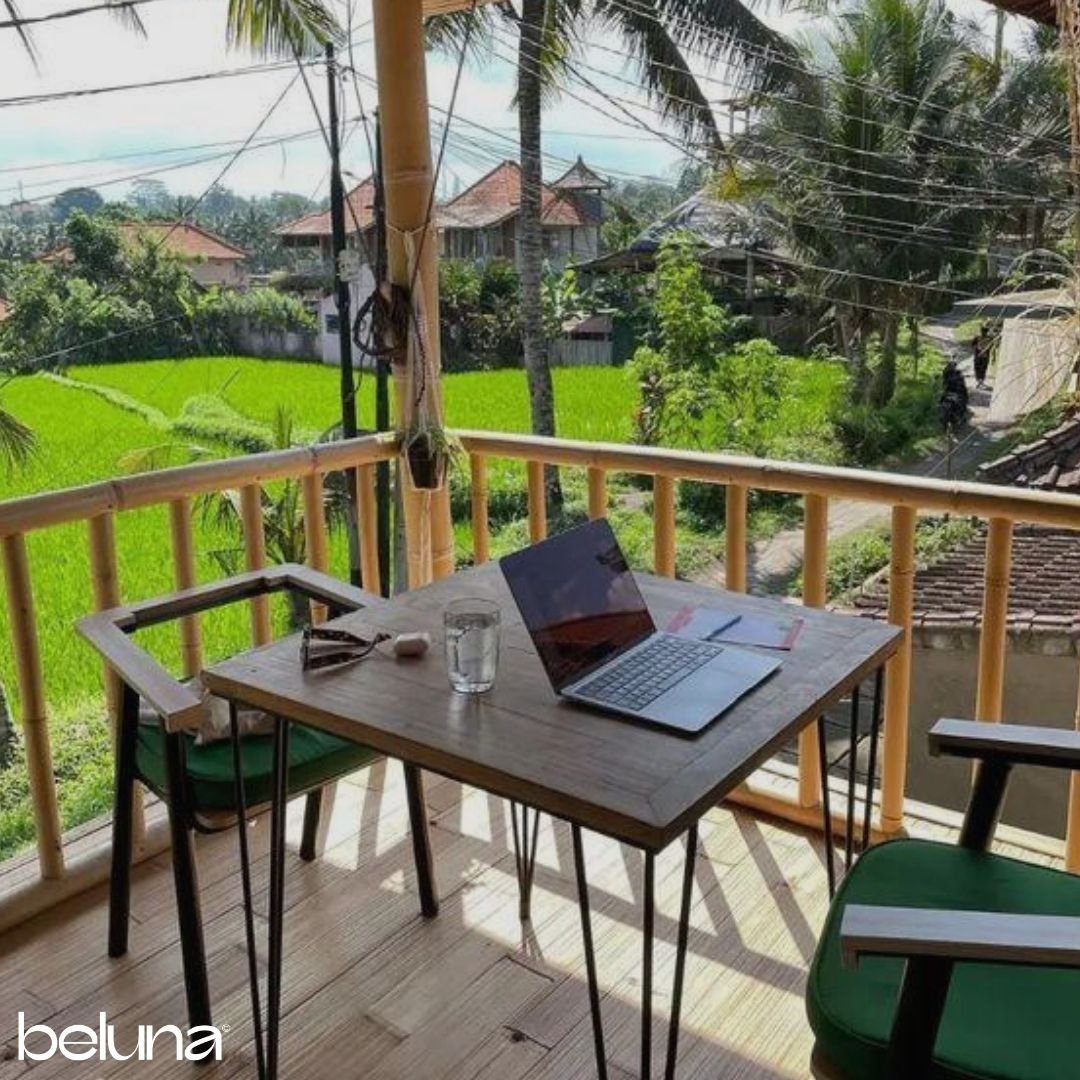 coworking space overlooking rice paddies with a laptop on the desk