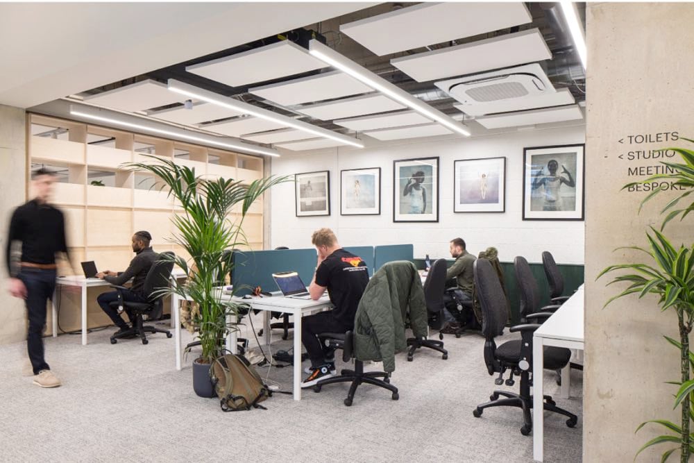 people coworking at desks in the UK