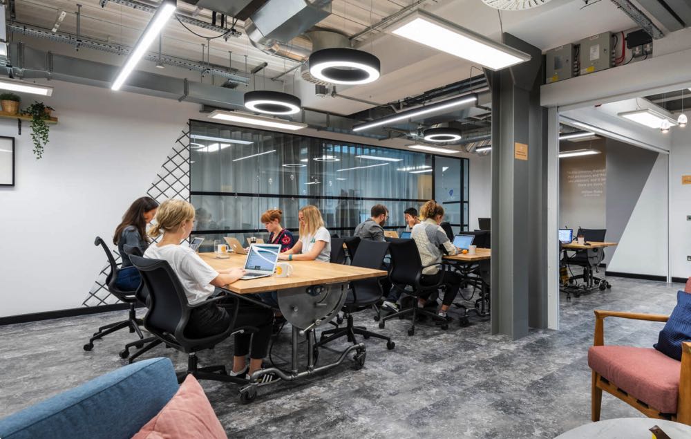 people working in an industrial coworking space in london