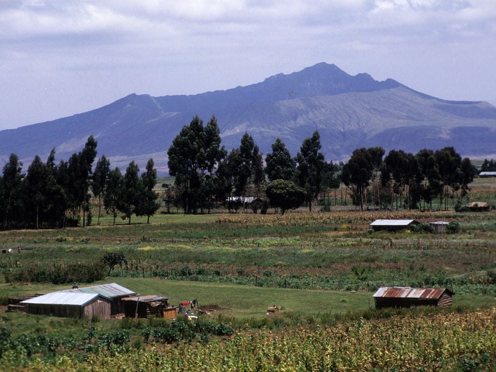 mount Longonot in the distance with some small homes in front