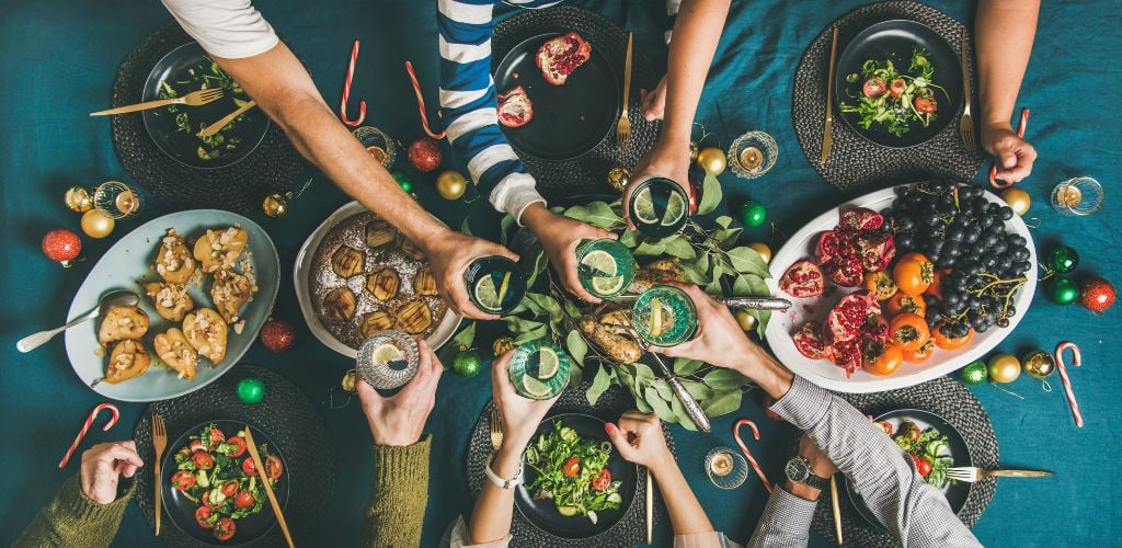 Group of people celebrating over food 