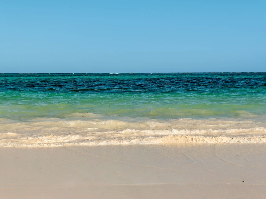 beach with white sand and blue water