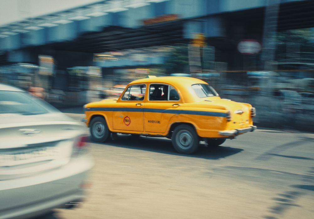 yellow taxi with blurred cars