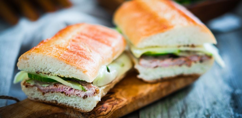 The Perfect Cuban Sandwich on a Wooden Cutting Board