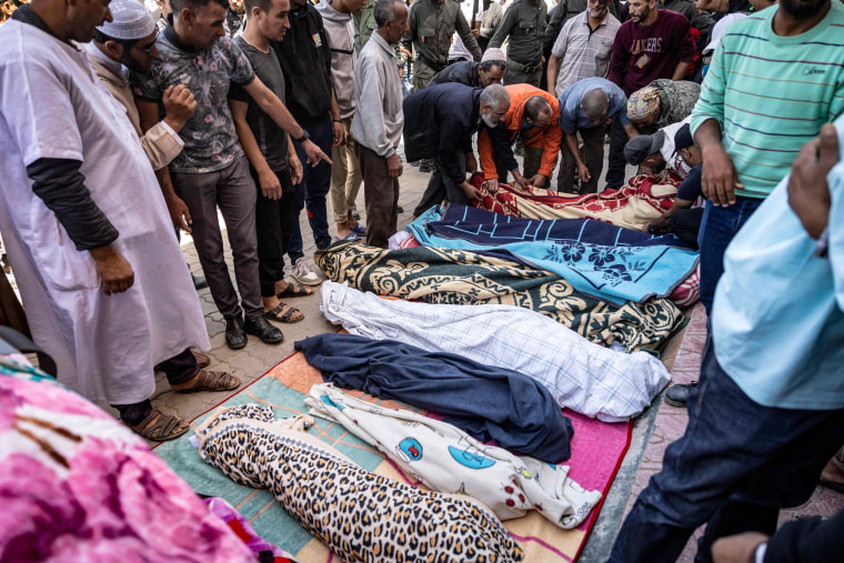 Relatives mourn in front of the bodies of earthquake victims in Moulay Brahim, Morocco, on Sept. 9, 2023. 