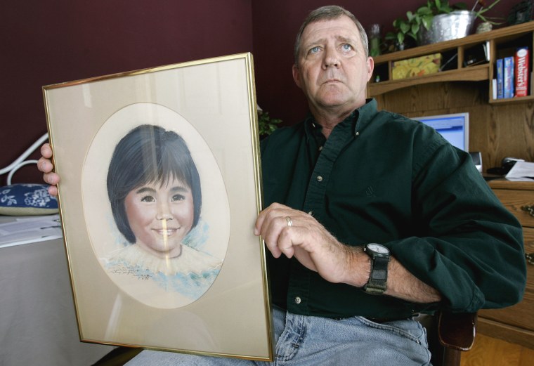 Image: Jerry Ensminger holds a portrait of his daughter, Janey, who died of leukemia at age 9, in 2007.