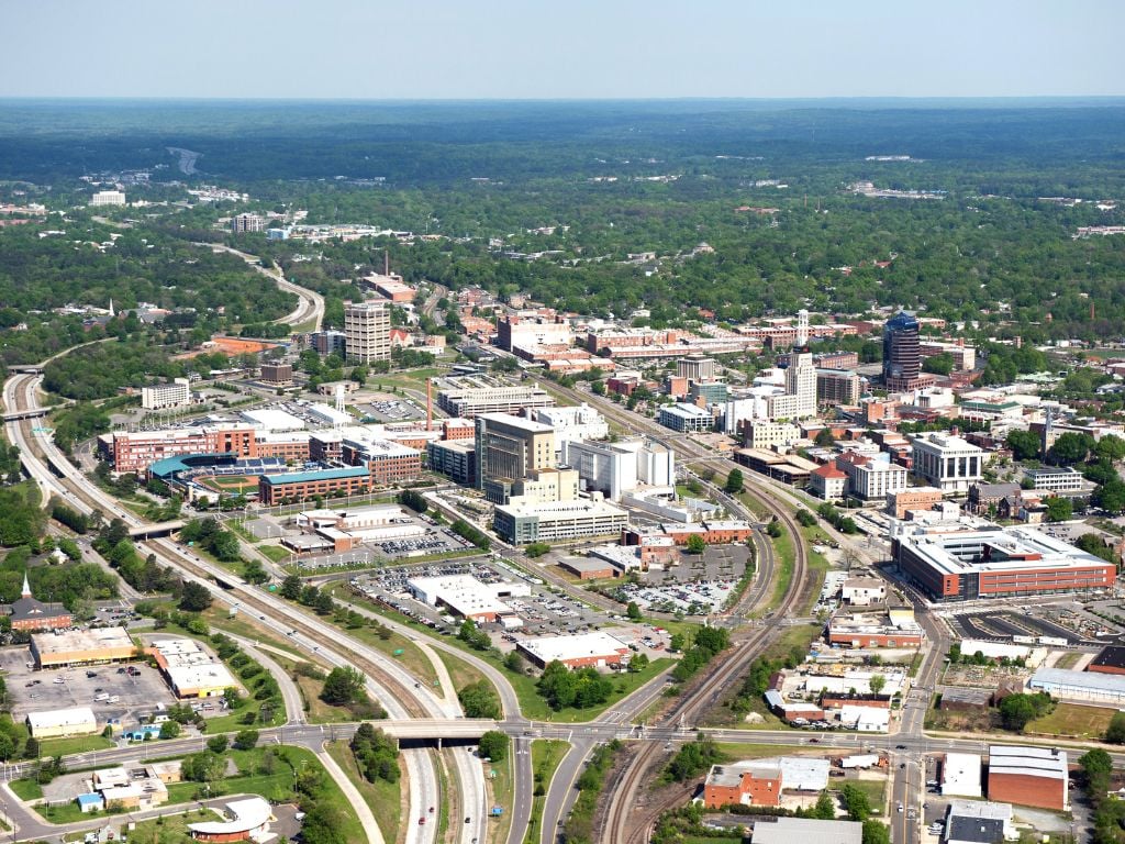 aerial view of durham NC with trees and buildings and highway