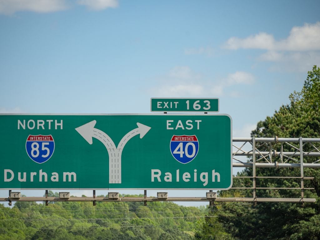 highway sign showing durham to the left and raleigh to the right
