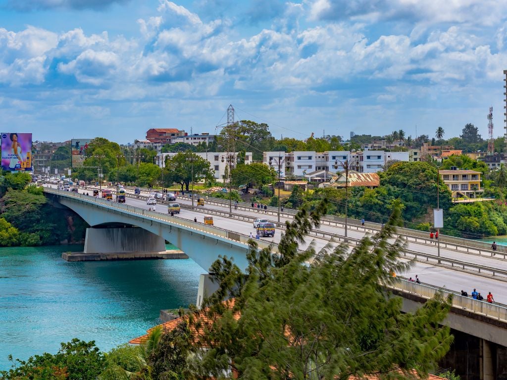 the nyali bridge in mombasa with cars and the river below