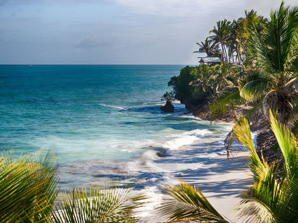 nyali beach mombasa with white sand, palm trees and blue water