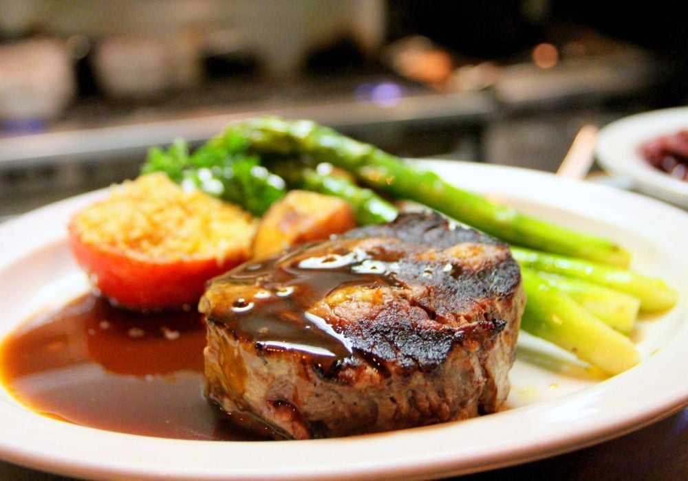 Selective focus photography of beef steak with sauce.