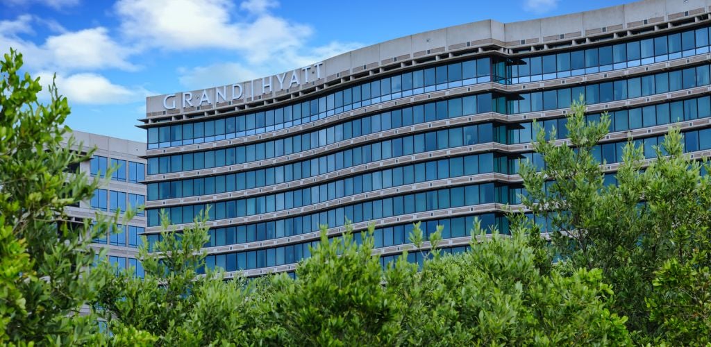 Grand Hyatt Hotel Building with trees below 