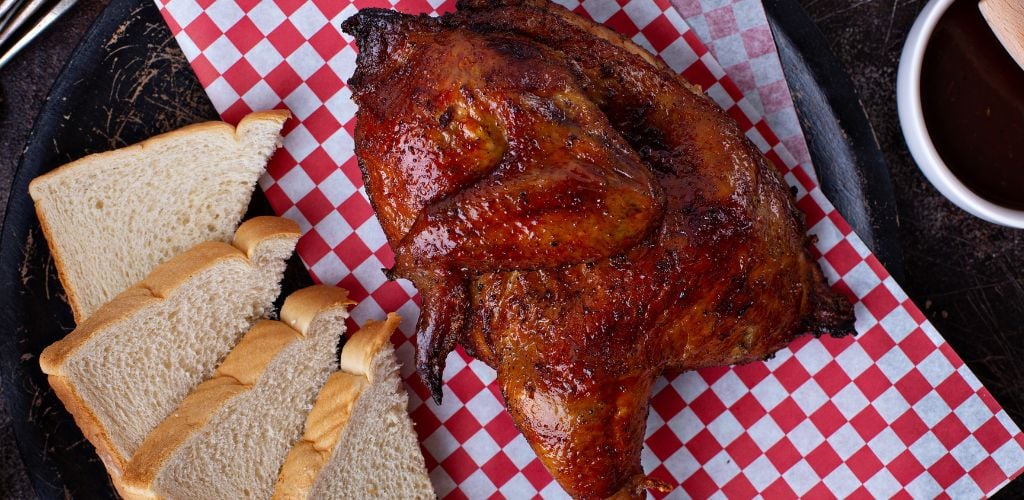 Delicious half smoked chicken with bread on the side