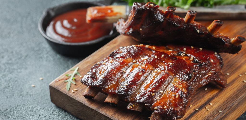 2 delicious rack of ribs on a wooden board.