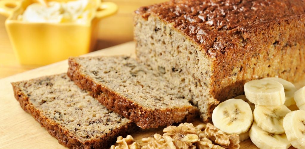 Delicious Banana Cake with banana and walnuts on the side