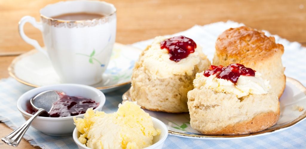 Cream tea with a side of bread with spreads