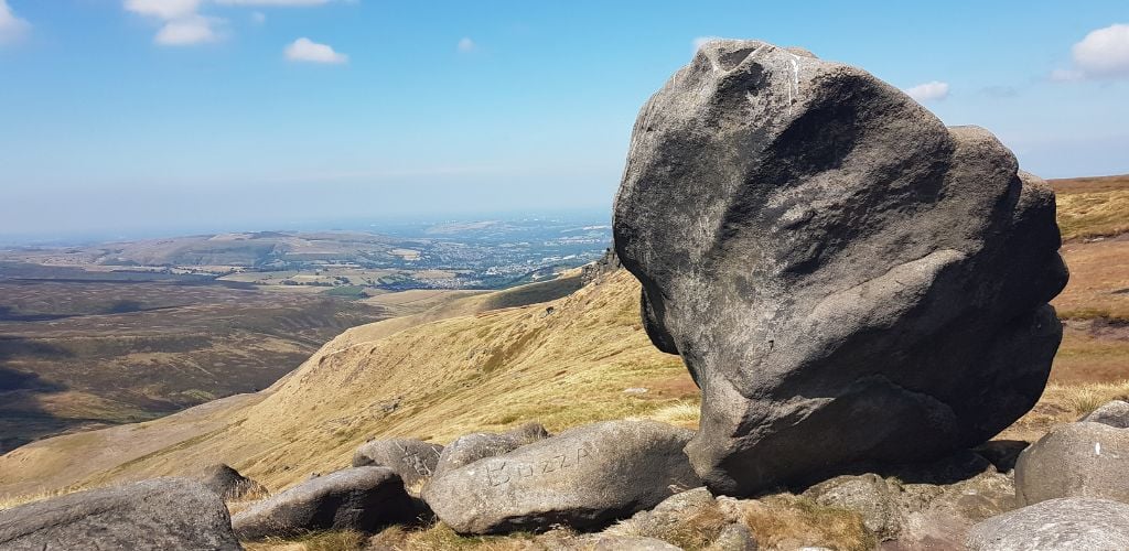 Mountainous with two large rocks, one of which has been sculpted "Bozza." 