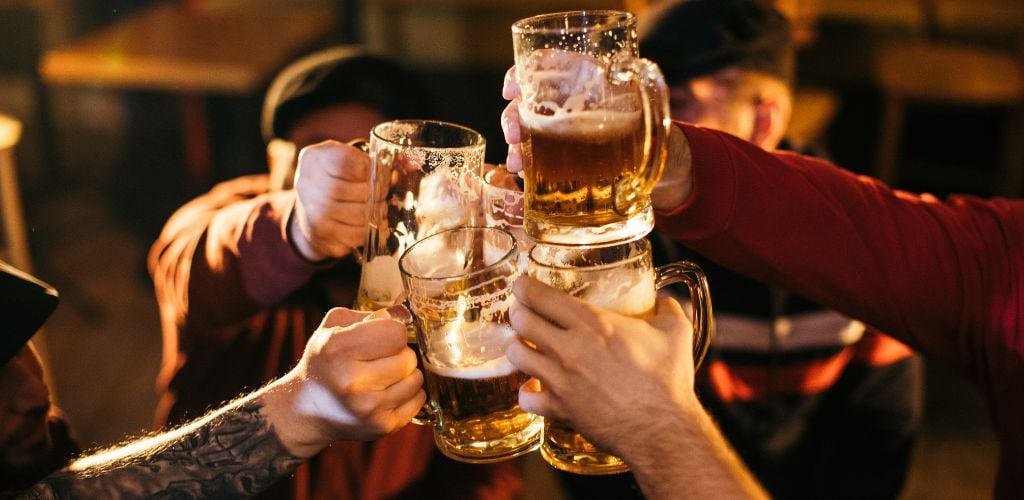 Group of friends celebrating over beer