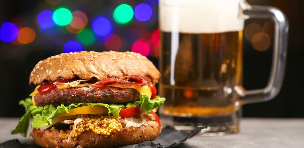 Burger and beer with circle lights at the back 