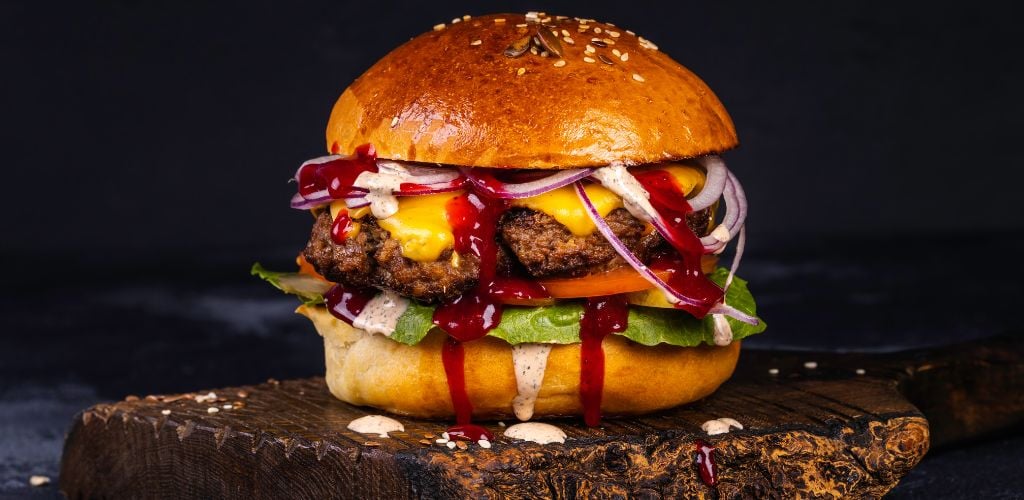 A delicious burger on a wooden plank 