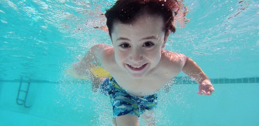 A boy swimming underwater.