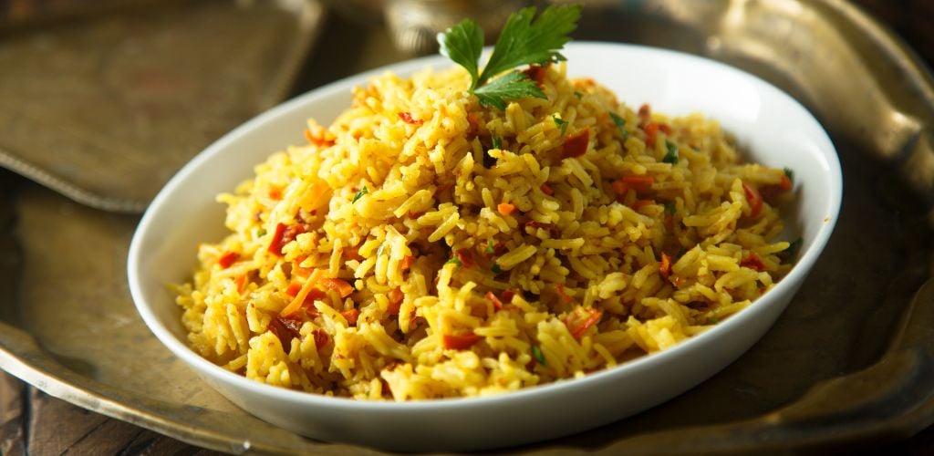 Pilau rice on a white plate.