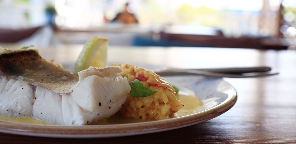 A plate of fish with rice. 