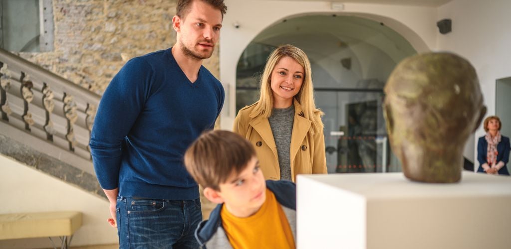 A photo of a family going through a museum 