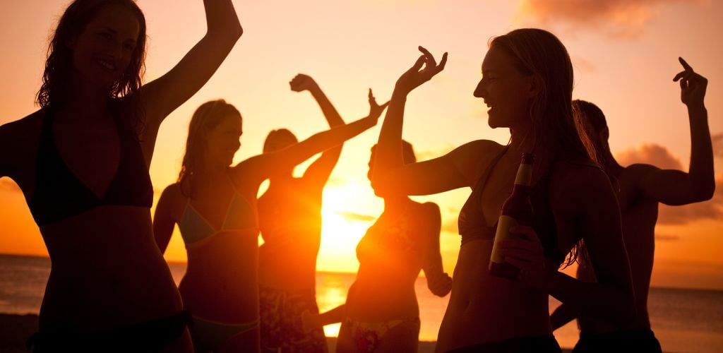 silhouette of girls partying in the beach