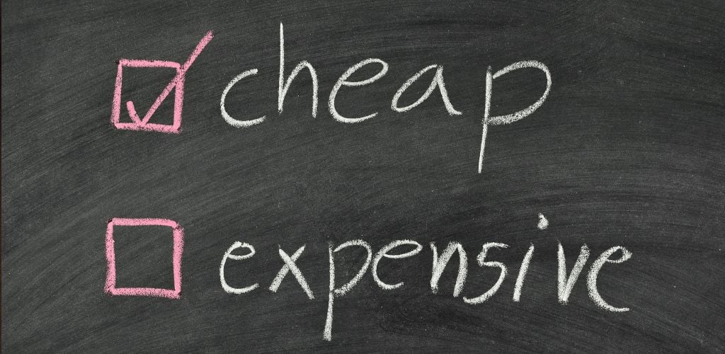 The word cheap is checked on a chalkboard