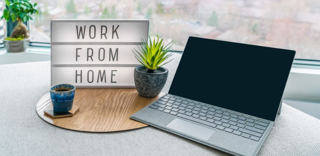 Work from home on a signage with a laptop on the side