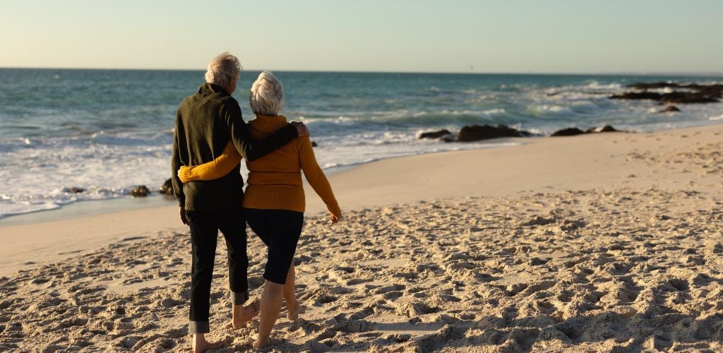 Couple enjoying a walk on the beach 