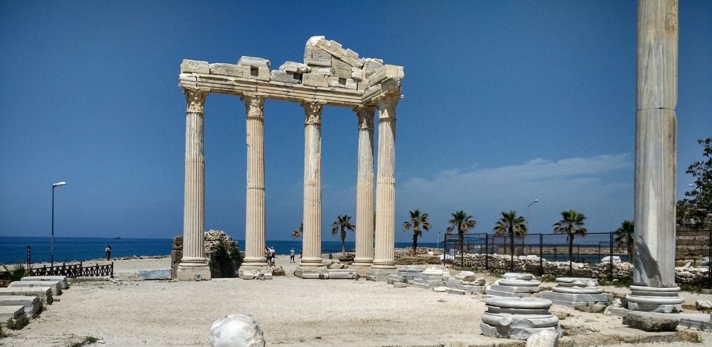 The white marble columns of the Hellenistic Temple of Athena stand near the harbor.
